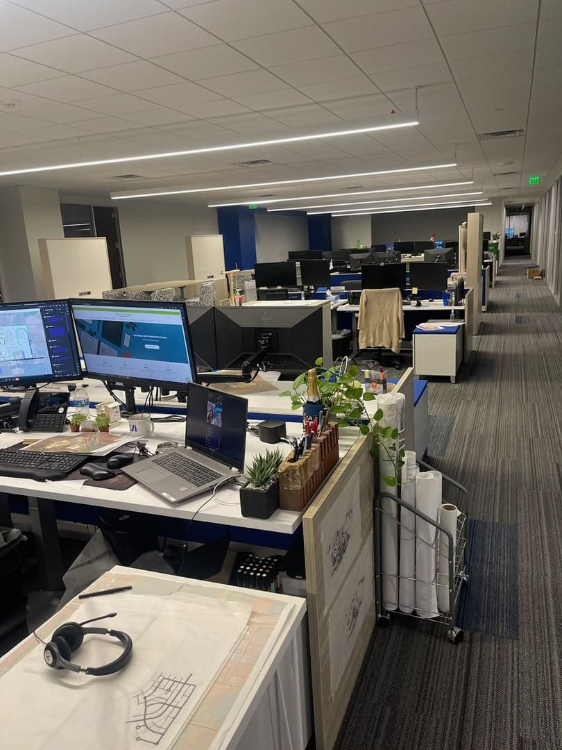 Back-office desks with monitors where reviewers check payroll and payout approvals